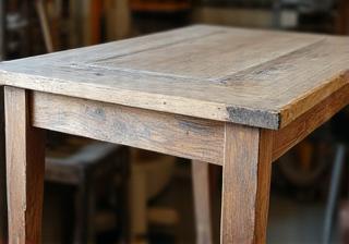 An intricate antique table part-way through the careful restoration process